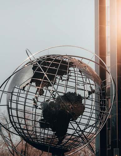 outer space gray sphere statue near building sphere